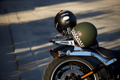 green and black motorcycle helmets on motorbike